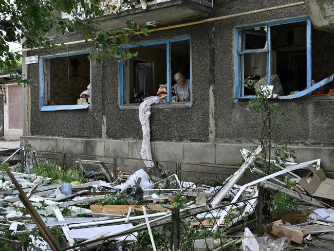 Lyudmila, 68, looks out of a blown window of her flat in a damaged residential building following overnight Russian strike in the town of Selydove, Donetsk region. Picture: Genya SAVILOV / AFP