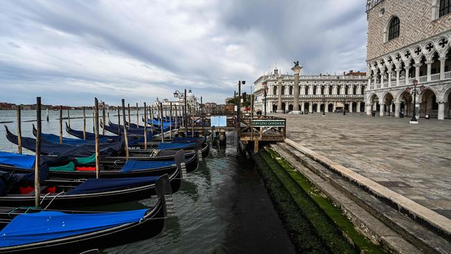 Gondolas moored at the Riva degli Schiavoni embankment by the Doge's Palace.