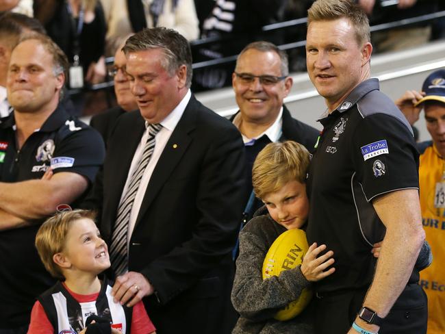 Nathan Buckley gets a hug from son Jett while Ayce Buckley chats to Eddie McGuire. Picture: Michael Klein