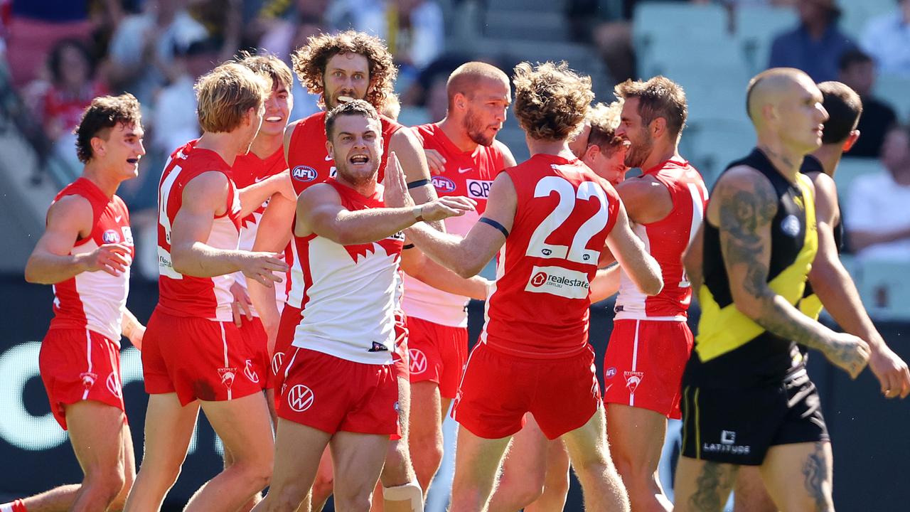 Sydneys Tom Papley gives it to Dustin Martin after Chad Warner kicked a goal.