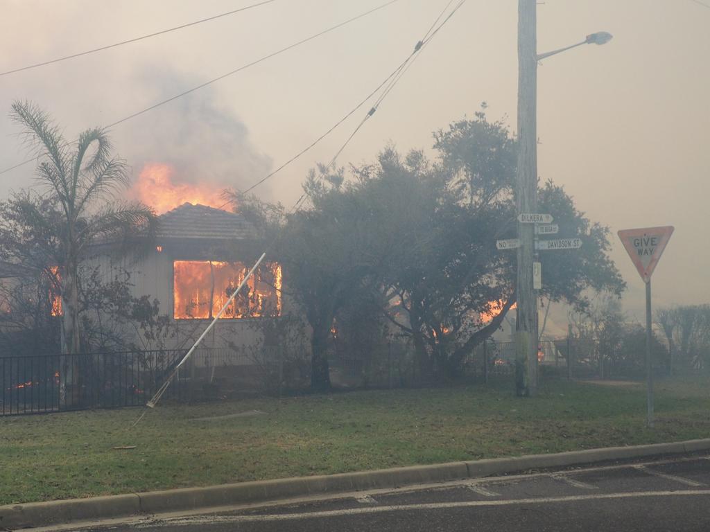 A bush fire rages in the town of Tathra on Sunday afternoon, March 18, 2018. Picture: John Ford