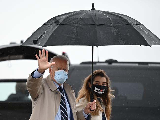 Joe Biden boards a flight to Florida accompanied by his granddaughter, Natalie. Picture: AFP