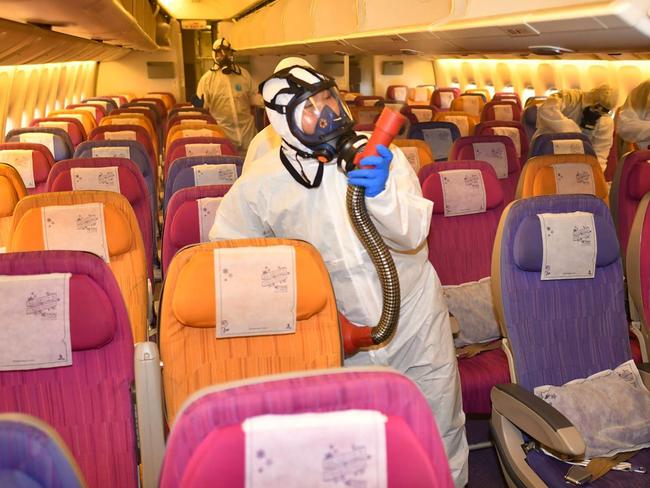 THAI Airways staff disinfecting an aircraft at the airline’s hangar in Bangkok, as a measure aimed at preventing the spread of novel coronavirus. Picture: AFP/THAI Airways