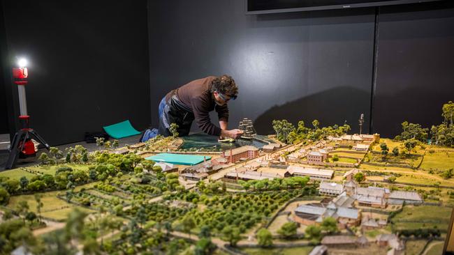 Model maker Ewin Wood with a one-of-a-kind model of Tasmania’s most infamous penal colony, Port Arthur, as it appeared during the convict period. The model had been hidden in storage for more than a decade and is once again on display at the Port Arthur Historic Site. Picture: Alastair Bett