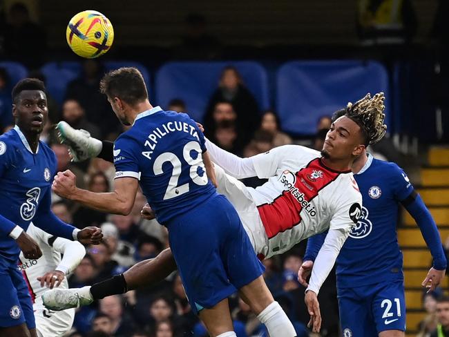 Chelsea's Spanish defender Cesar Azpilicueta (centre left) is hurt when kicked by  Southampton's French striker Sekou Mara (2R) attempting this overhead kick during the English Premier League football match between Chelsea and Southampton at Stamford Bridge in London on February 18, 2023. (Photo by Glyn KIRK / AFP) / RESTRICTED TO EDITORIAL USE. No use with unauthorized audio, video, data, fixture lists, club/league logos or 'live' services. Online in-match use limited to 120 images. An additional 40 images may be used in extra time. No video emulation. Social media in-match use limited to 120 images. An additional 40 images may be used in extra time. No use in betting publications, games or single club/league/player publications. /