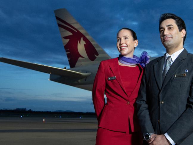 BRISBANE, AUSTRALIA - DECEMBER 04: In this image released on December 12, crew from both Virgin Australia and Qatar Airways beside a Qatar Airways Boeing 777 at Brisbane Airport on December 04, 2024 in Brisbane, Australia. A new partnership between the two airlines has been launched which will deliver more value and choice to Australians, providing opportunities to travel to over 100 destinations across Europe, the Middle East and Africa. From December 12, Aussies can book Virgin Australia's new direct services from Sydney, Brisbane and Perth to Doha for travel from June 2025, with Melbourne set to launch later in 2025. These flights will be operated by Virgin Australia using Qatar Airways' spacious Boeing 777s, renowned for their Qsuite Business Class. (Photo by James D. Morgan/Getty Images for Virgin Australia)