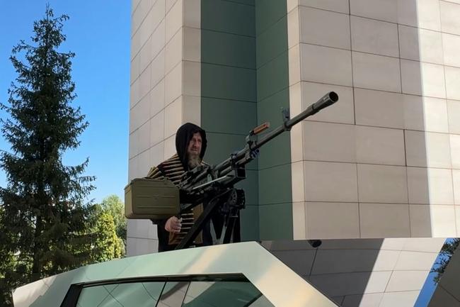 This video grab taken from a handout footage released on the official Telegram account of the Head of Chechen Republic on August 17, 2024, shows Chechen leader Ramzan Kadyrov standing atop a gun-mounted Tesla Cybertruck in Grozny, Chechnya.