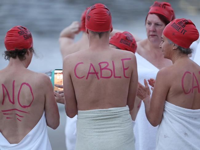 DARK MOFO 2019: Peaceful anti-cable car protests at the nude solstice swim at Long Beach, Sandy Bay. Picture: LUKE BOWDEN