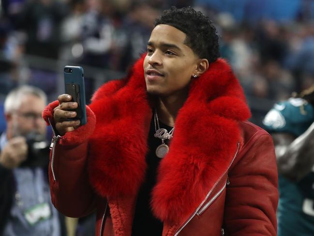 Chistian Casey Combs uses his cell phone prior to Super Bowl LII between the New England Patriots and the Philadelphia Eagles at U.S. Bank Stadium on February 4, 2018 in Minneapolis, Minnesota. Picture: AFP