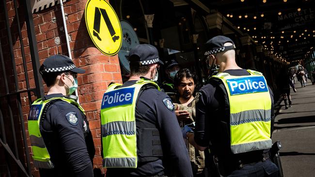 A man refuses to wear a mask issued to him by Victoria Police at the Queen Victoria Market during the height of the lockdown in Melbourne. Picture: Getty Images