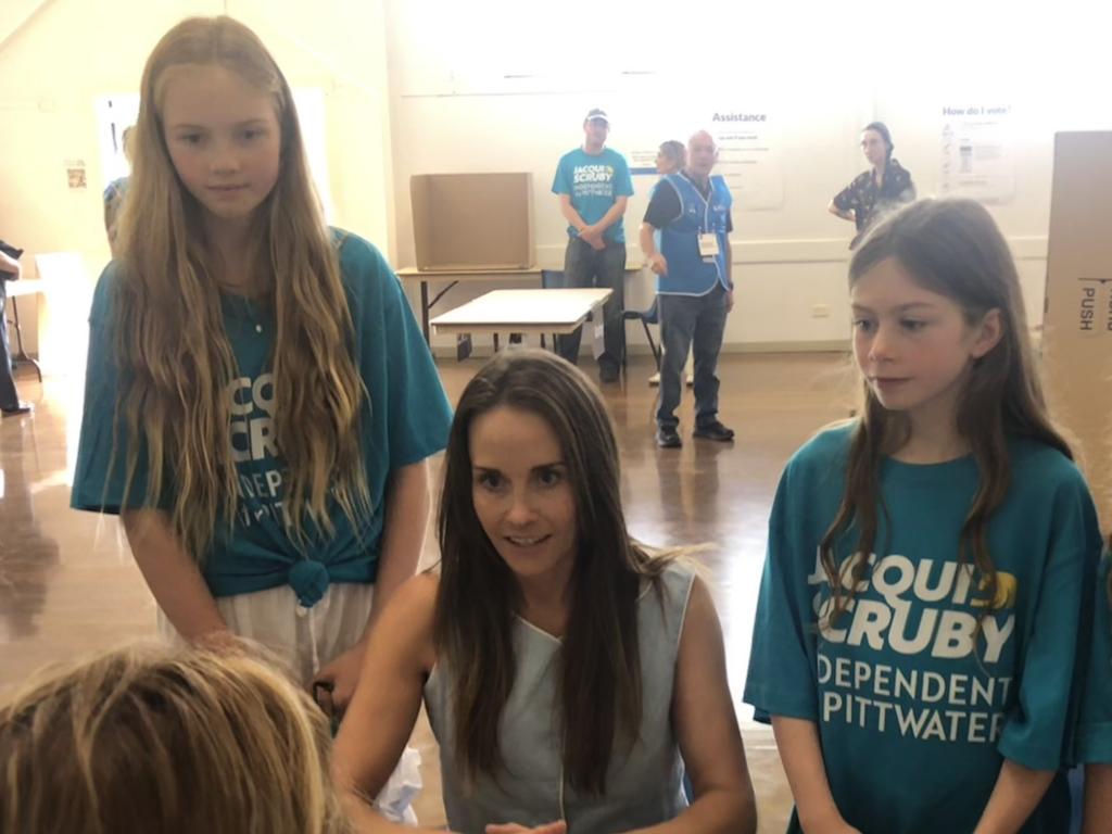 Independent candidate in the Pittwater by-election, Jacqui Scruby, voting in the Pittwater by-election at the Ted Blackwood Memorial Hall in Warriewood, watched by her daughters. Picture: Jim O’Rourke