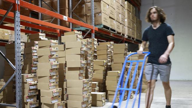 Warehouse staff at Ascent Shoes in Virginia, Brisbane on Wednesday, March 27, 2019. (AAP image/Claudia Baxter)