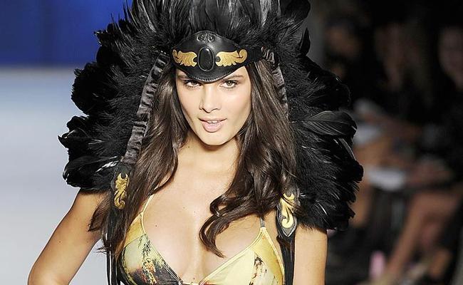 BIRDS OF A FEATHER: A model takes to the catwalk during Rosemount Fashion Week in Sydney wearing one of Terry Cronin’s feather headdresses.