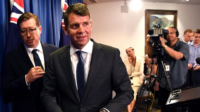 Premier Mike Baird and deputy premier Troy Grant leave the press conference on October 11. Picture: AFP