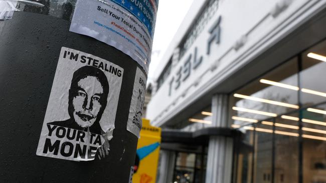 A flyer protesting Elon Musk is shown on a utility pole outside a Tesla dealership on March 12 in San Francisco. Picture: Justin Sullivan/Getty Images