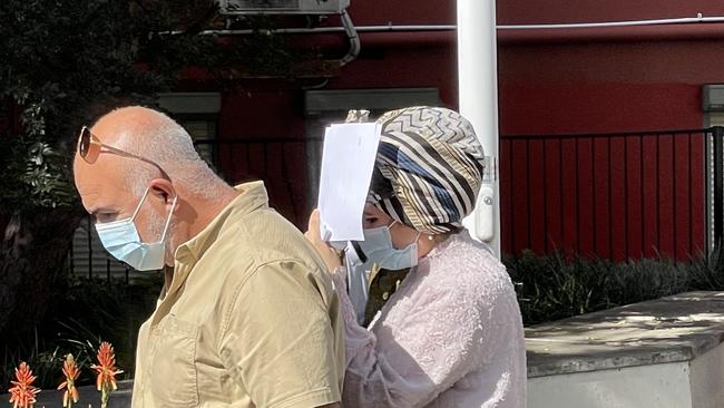 An “ashamed” Mawadha Mahmoud covered her face as she left Wollongong Local Court on Tuesday. Picture: Dylan Arvela