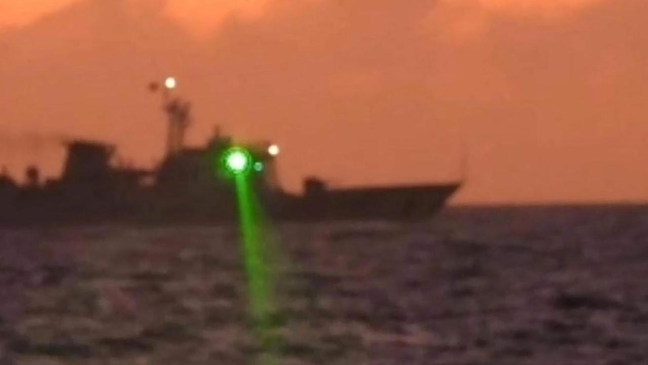 This handout photo taken on February 6, 2023 shows a Chinese Coast Guard vessel shining a ‘military grade laser light’ at a Philippine Coast Guard boat nearly 20 kilometres from Second Thomas Shoal, in the Spratly Islands in the disputed South China Sea. Picture: Philippine Coast Guard/AFP