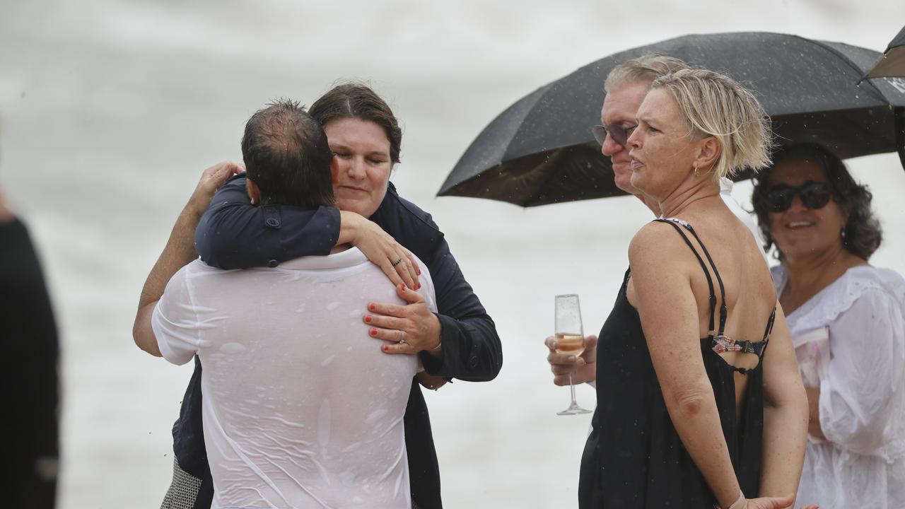 Family and friends of 16-year-old alleged stabbing victim Balin Stewart gather to pay tribute on his home beach at Buddina. Picture: Lachie Millard