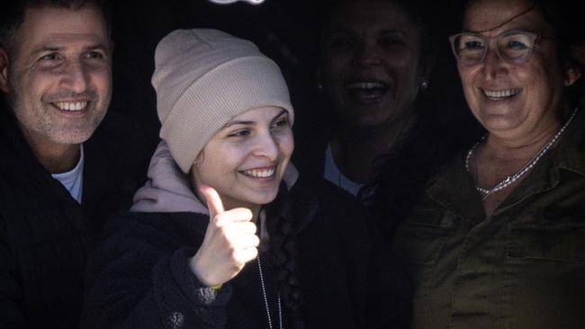 Daniella Gilboa gives a thumbs up to the waiting crowd from the door of the helicopter after arriving at Belinson-Schneider Hospital. Picture: Getty Images.