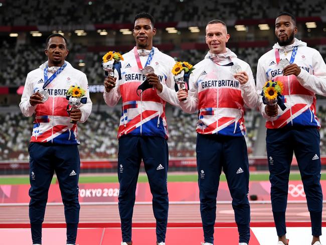 TOKYO, JAPAN - AUGUST 07:  Silver medal winners CJ Ujah, Zharnel Hughes, Richard Kilty and Nethaneel Mitchell-Blake of Team Great Britain stand on the podium during the medal ceremony for the Men's 4 x 100m Relay on day fifteen of the Tokyo 2020 Olympic Games at Olympic Stadium on August 07, 2021 in Tokyo, Japan. (Photo by Matthias Hangst/Getty Images)