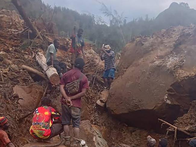 This handout photo taken on May 26, 2024 and received on May 27 courtesy of local community leader Steven Kandai shows people digging at the site of a landslide at Mulitaka village in the region of Maip Mulitaka, in Enga Province, Papua New Guinea. More than 2,000 people have been buried in a Papua New Guinea landslide that destroyed a remote highland village, the government warned May 27 as it called for international help in the rescue effort. (Photo by Handout / COURTESY OF STEVEN KANDAI / AFP) / RESTRICTED TO EDITORIAL USE - MANDATORY CREDIT "AFP PHOTO / COURTESY OF STEVEN KANDAI - NO MARKETING NO ADVERTISING CAMPAIGNS - DISTRIBUTED AS A SERVICE TO CLIENTS - NO ARCHIVE