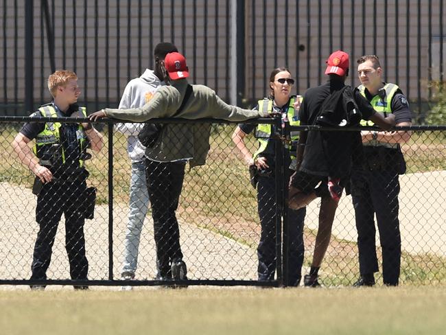 Police talk to youths at the trashed Ecoville Community Park in Tarneit. Picture: Nicole Garmston