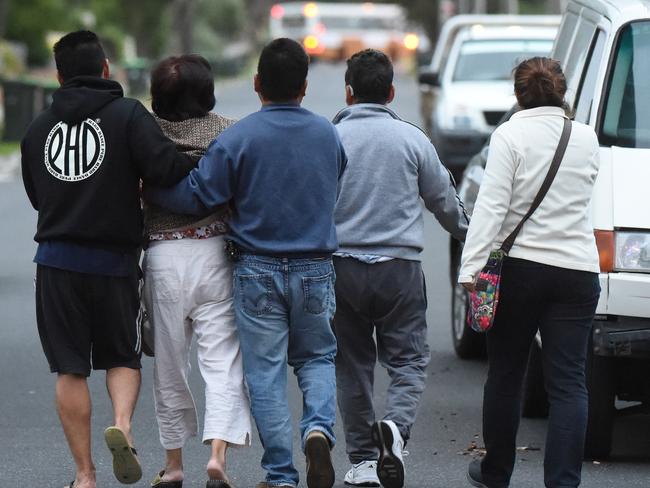 People, believed to be family members, at the scene. Picture: Tony Gough