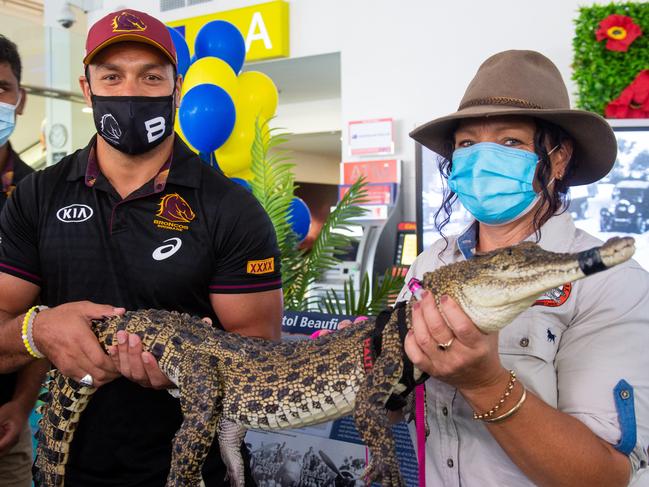 Brisbane Broncos’ captain Alex Glenn holds a crocodile with Kiley Lenehan from Crocodylus Park. Photo: Che Chorley