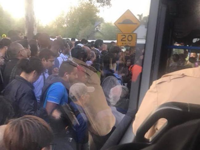 Commuters wait for replacement buses at Kensington Station.