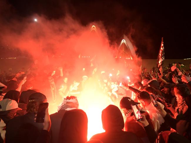 Supporters taking part in a “Rally For A Free Palestine” protest on the forecourt of the Sydney Opera House, lighting flares and fireworks and burning the Israeli flag. Picture: Jeremy Piper/NCA Newswire