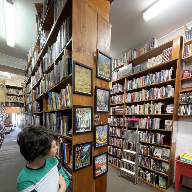 Young customer Daniel Reynolds looks through the bookshelves Bendigo Book Mark shop. Picture: Julieanne Strachan