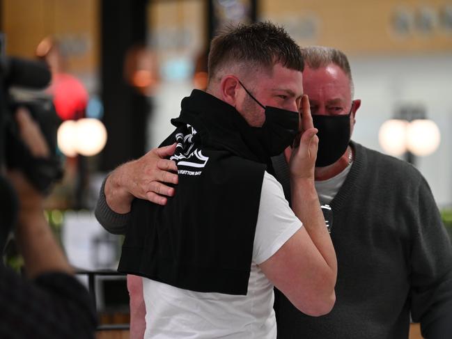 Tears of joy flowed as they embraced each other after he landed on the first flight in from Melbourne. Picture: Naomi Jellicoe