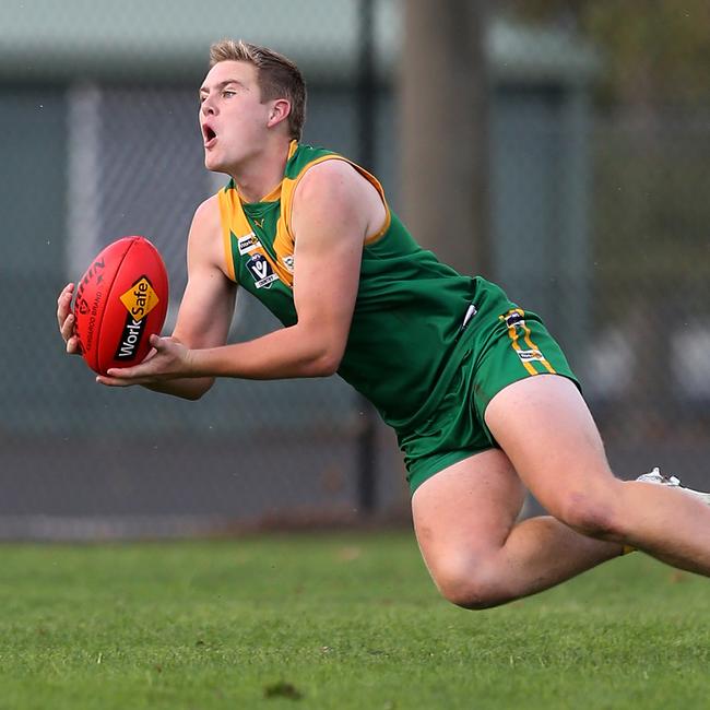 Leongatha’s Jenson Garnham takes a mark close to the ground against Sale. Picture: Yuri Kouzmin