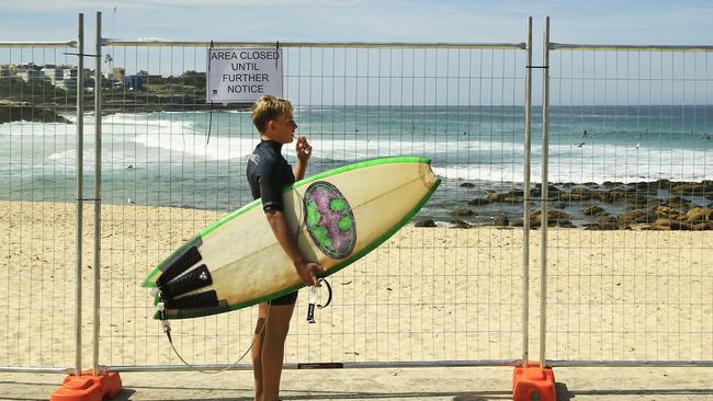 A surfer looks at a fenced off Bronte beach on March 22. Picture: Mark Evans/Getty Images