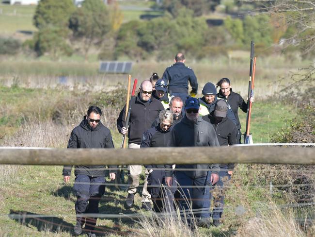 Crews scour the area surrounding the dam in Buninyong. Picture: Ian Wilson