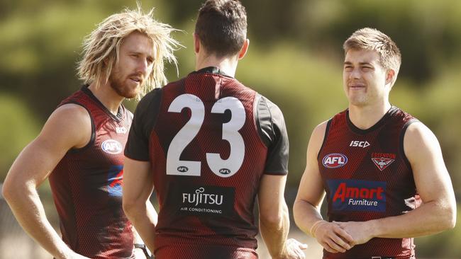 Dyson Heppell (left), David Myers and Zach Merrett talk at training this week.