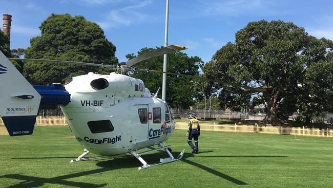 A CareFlight emergency helicopter medical team landed in St Leonard's Park, North Sydney, to treat a man seriously injured in a motorcycle incident on the Warringah Freeway. Picture: CareFlight