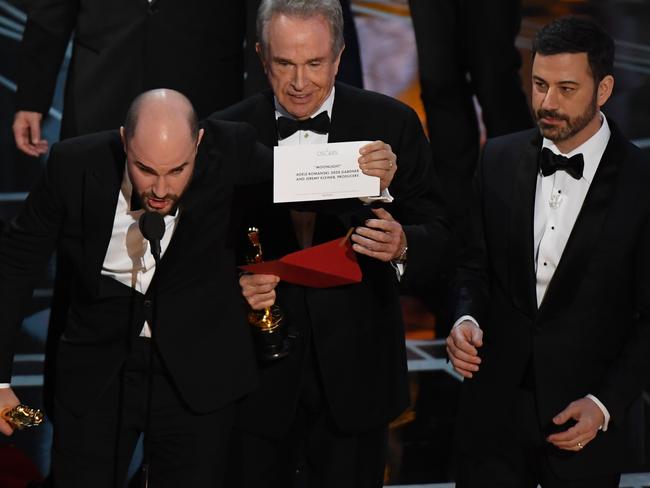 La La Land producer Jordan Horowitz (left), presenter Warren Beatty and host Jimmy Kimmel try to make sense of the blunder. Picture: AFP/Mark Ralston