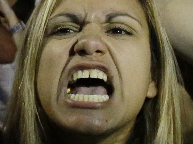 Supporters of the No vote react after the first results of the referendum at Syntagma square in Athens, Sunday, July 5, 2015. Greece faced an uncharted future as its interior ministry predicted Sunday that more than 60 percent of voters in a hastily called referendum had rejected creditors' demands for more austerity in exchange for rescue loans.(AP Photo/Petros Karadjias)