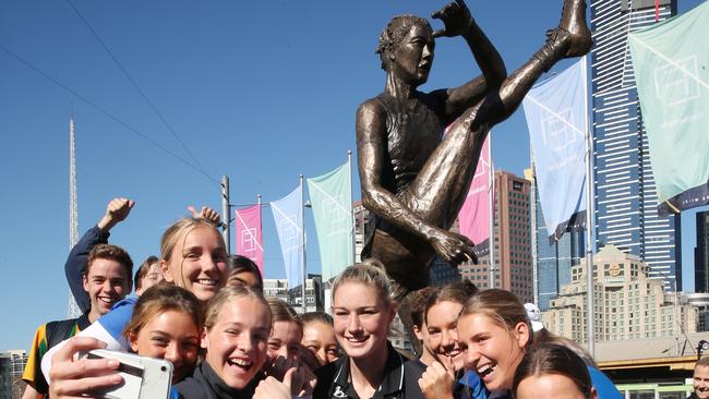 Harris gets a selfie with fans at the unveiling of a prototype statue that will be made to recognise her achievements in women's football. Picture: David Crosling