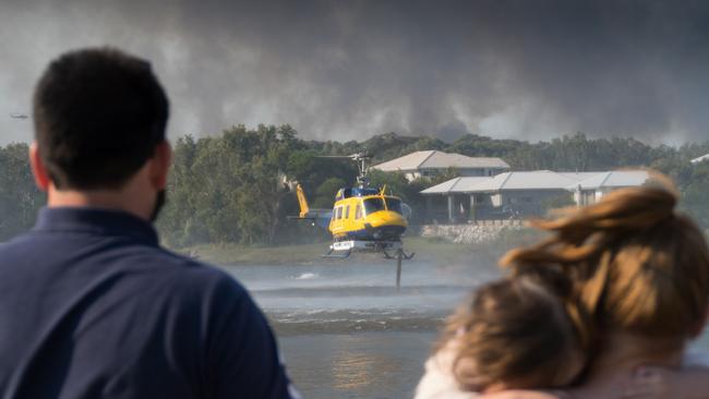 Helicopters taking on water to waterbomb the fire. The waterbombing at the Weyba Downs area, adjacent to Peregian Springs, Peregian Spring Golf Course. Picture: Ian Martin