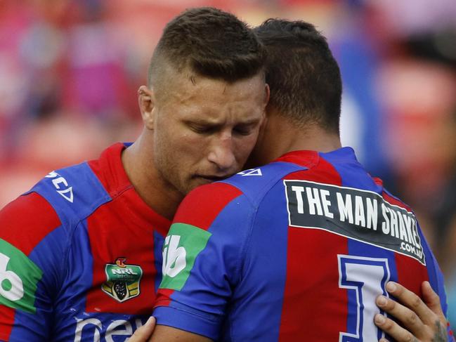 Tariq Sims comforts Dane Gagai of the Knights after being beaten by the Sharks in the Round 10 NRL match between the Newcastle Knights and the Cronulla Sharks at Hunter Stadium, Newcastle, Sunday 15th May , 2016. (AAP Image/Darren Pateman) NO ARCHIVING, EDITORIAL USE ONLY