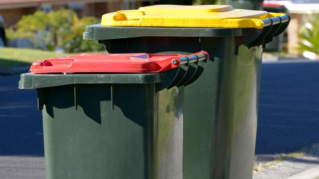 In Melbourne the red lid is for rubbish and the yellow lid for recycling.