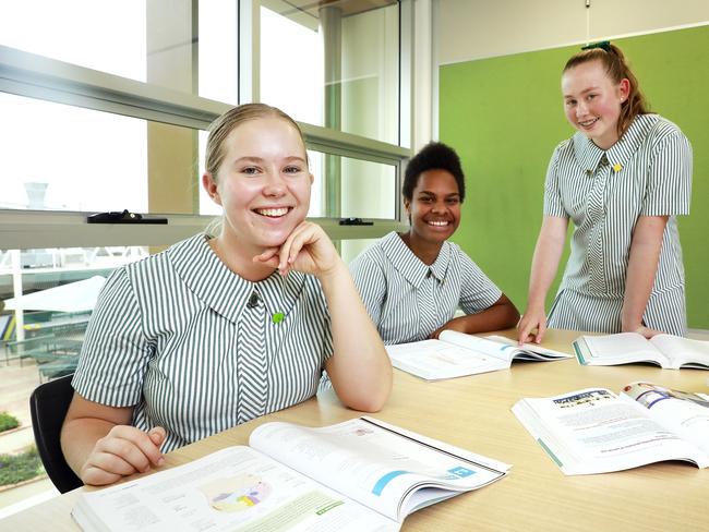 Sophia Kelly, 17, Cleone Wrakuale, 16, and Sophia Buchanan, 16, pose at Clayfield College in Clayfield, Brisbane on Thursday, January 23, 2020. The college is offering new subjects. (AAP Image/Claudia Baxter)