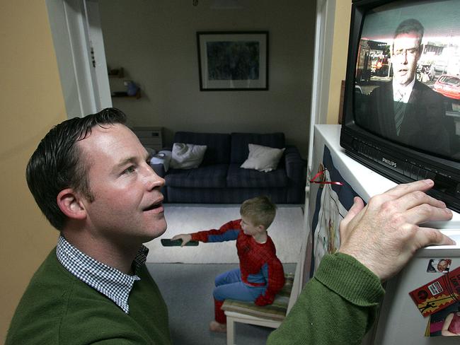 How Tasmanians start the day, Leader of the Liberal Party Will Hodgman tunes into the Sunrise television program on the portable TV while his son William, 4, watches the big television