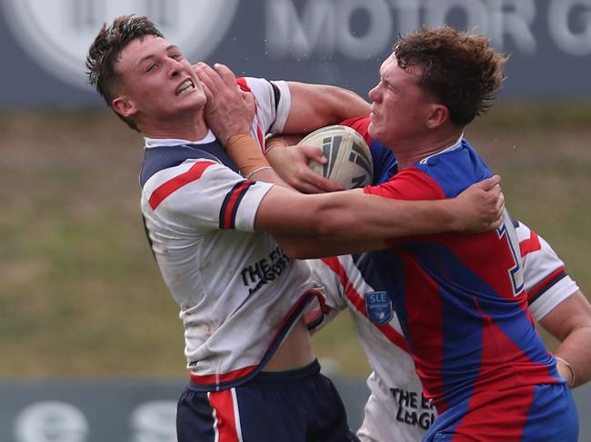 Roosters Tulyson McCulloch fended off by Newcastles Noah McNamara SLE Andrew Johns Cup Newcastle Knights v Central Coast Roosters at Cessnock Sportsground Saturday 2nd March 2024.pic Sue Graham