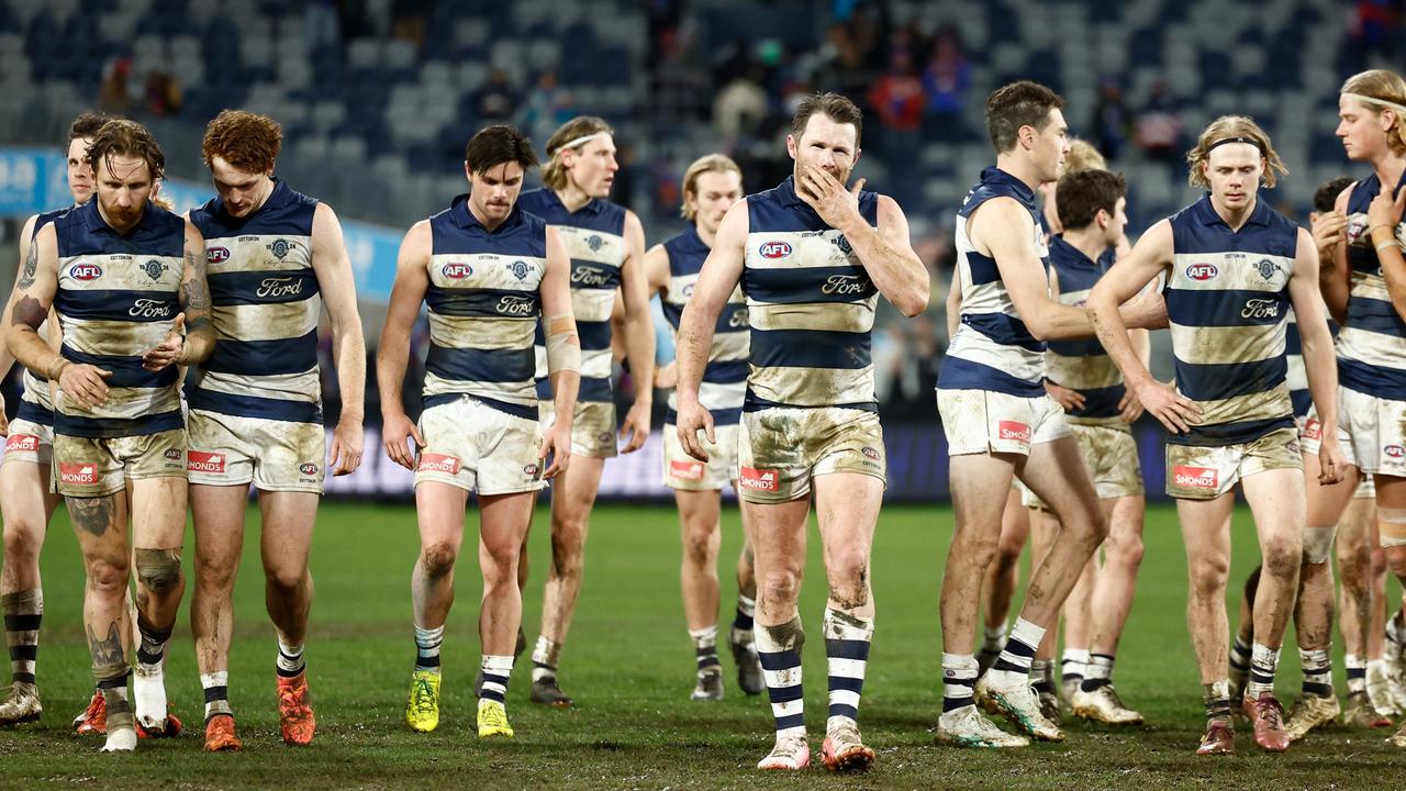 A dejected cats outfit leave a muddy Kardinia Park on Saturday night. (Photo by Michael Willson/AFL Photos via Getty Images)