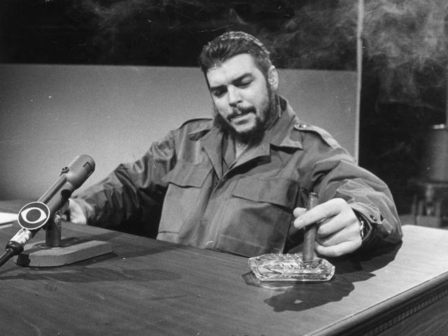 Cuban industry minister Ernesto "Che" Guevara smokes a cigar during an interview with CBS news in December 1964.