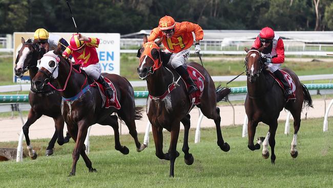 Dunatun, ridden by Nathan Day (centre, orange silks) wins the Benchmark Handicap 1250 metres, Race 6 at Cannon Park, Woree. Picture: Brendan Radke