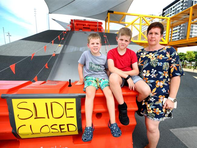 Beck Stephenson with her sons Archie (4) and Jack (7) at the large slide that was closed just days after the Hercules Street Park opened in Hamilton. Photo: Adam Head